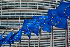 European Union flags wave in front of the European Commission building in Brussels, Belgium.