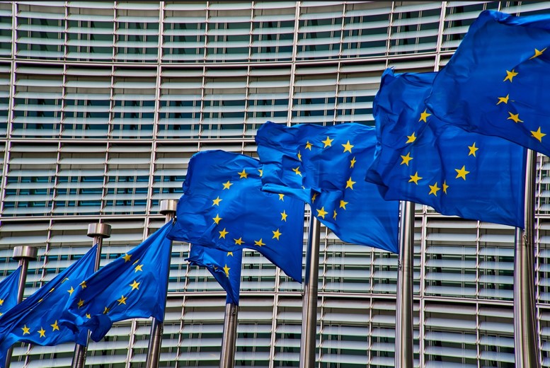 European Union flags wave in front of the European Commission building in Brussels, Belgium.